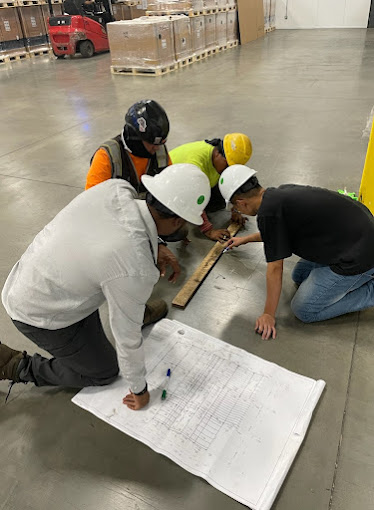 A group of men working on a project in a warehouse